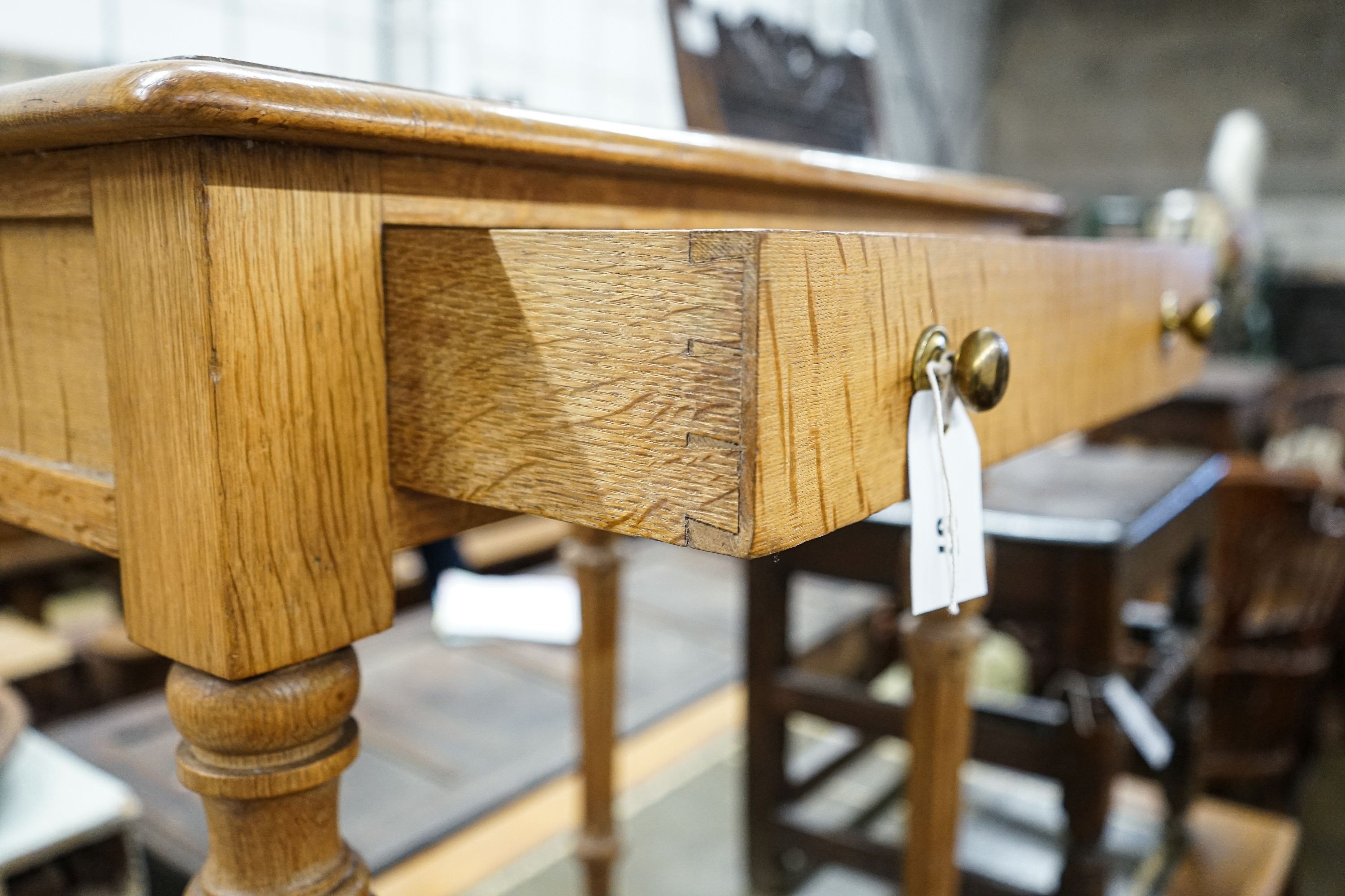 A Victorian golden oak side table, with single drawer, turned and fluted legs on brass castors, width 68cm, depth 46cm, height 73cm